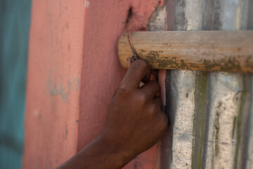 A human hand holding a old bamboo