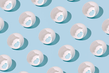 Eggshells, creative pattern on a pastel blue background.