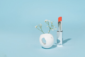 Springtime holidays creative aesthetic layout with flowers and lipstick