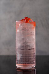 Colors and textures blend in an enticing cocktail, garnished with vibrant fruits, showcasing the artistry of mixology at a stylish dining venue during a lively evening