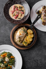 Delight in an array of gastronomic masterpieces, from savory main courses to refreshing drinks, showcasing the culinary talent of the restaurant in a warm and inviting atmosphere