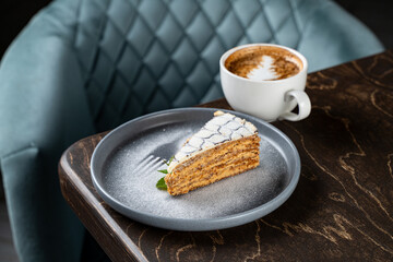 Indulging in a delicious slice of cake paired with aromatic coffee at a charming cafe. Moments of relaxation surrounded by inviting decor and warm ambiance