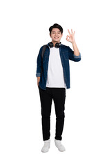 Full body image of young Asian male student using phone and posing on PNG background	