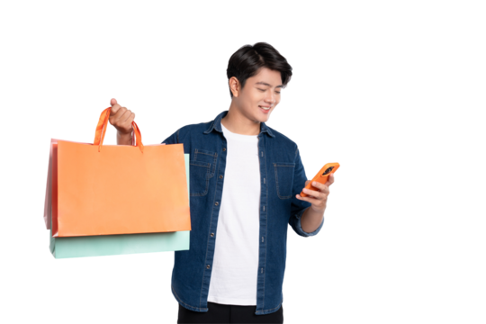 Portrait of young Asian man using phone and holding shopping bag posing on PNG background	