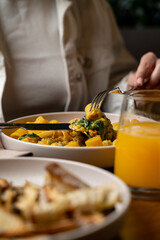 Gourmet plates filled with vibrant ingredients are savored at a cozy restaurant while a glass of fresh juice completes the culinary delight. A moment of pure gastronomic pleasure unfolds