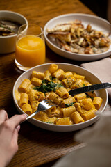 Savor the experience of indulging in rich, freshly prepared pasta dishes alongside a refreshing drink, all set in an inviting and stylish eatery