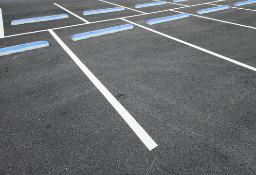 Empty city parking lot with white lane markings on asphalt