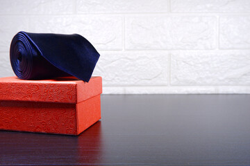 A necktie rolled on gift box closeup view , gift concept 