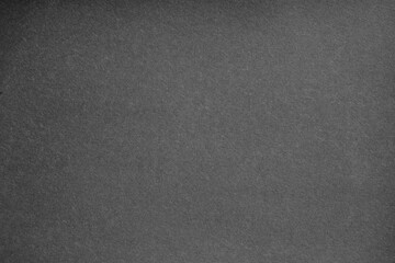 Fototapeta premium Macro close-up of black paper material with grainy detail