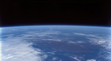 Earth seen from space, a vast blue orb, clouds swirling