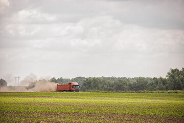 Truck driving through a farm field