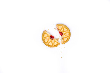 Broken biscuit delicacy with Heart-Shaped Jam: A broken biscuit, reveals a vibrant heart-shaped jam...