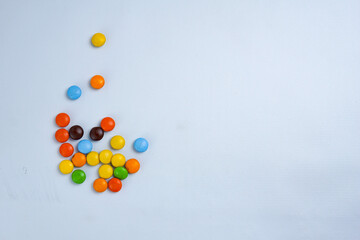 Colorful Candies: A vibrant collection of small, round candies in an array of hues, inviting a...