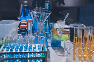 Scientist pipetting medical samples into microplate in laboratory
