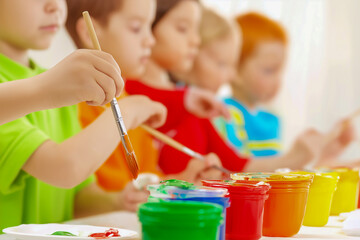 Children focused on painting with watercolors at a classroom table, surrounded by classmates engaged in creative art activities, showcasing the joy of artistic expression and learning