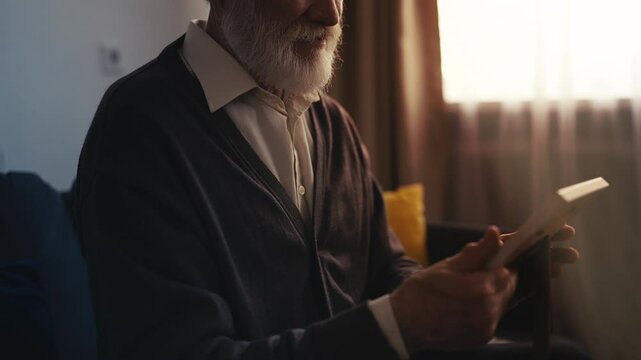 Desperate senior man looking at photo, missing late wife and feeling sorrow
