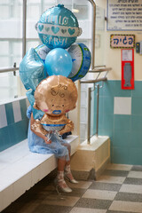 little girl with balloons indoors