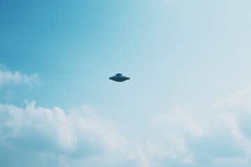 solitary minimalistic ufo silhouette hovering in expansive cloudless blue sky with ample copy space beyond its gleaming