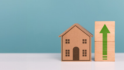 Home tax, taxation, property profit and property fee. Miniature cardboard box house with green up arrow icon indicate residential tax rate increased residential tax rates