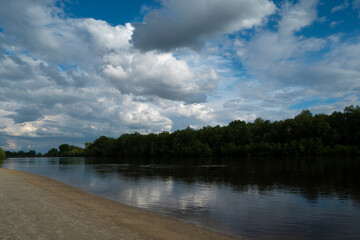 Landscape with river and clouds.
Reflection of clouds on the water surface gives the image a sense of volume and depth of space.
