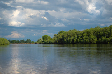 Landscape with river and clouds.
Reflection of clouds on the water surface gives the image a sense of volume and depth of space.
