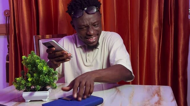 young black man happily using the voice note method of sending message
