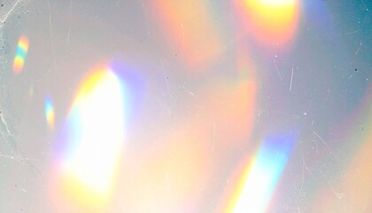 Blurred rainbow light refraction texture overlay effect for photo and mockups. Organic drop diagonal holographic flare on a white wall. Shadows for natural light effects