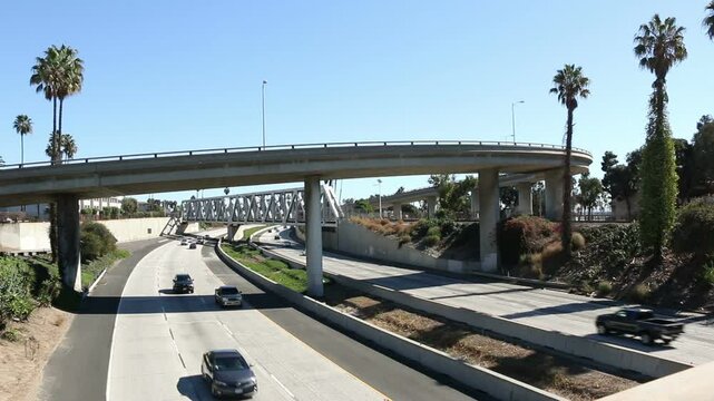 The 101 freeway with vehicles as it passes through Ventura, California on a sunny day.
