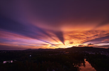 Glowing Sunset With Vibrant Colors Over Calm Landscape and Reflected River..