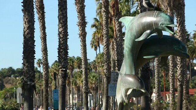 Seagull landing on the dolphin statue at the corner of State Street and Cabrillo, the Stearns Wharf in Santa Barbara, California.
