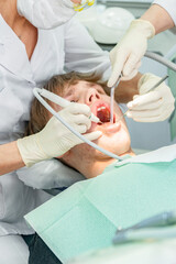 Obraz premium Teenager undergoes dental procedures in a bright clinic with professionals attending to oral health needs