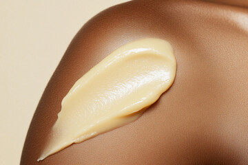 Close-up of skincare cream applied to shoulder.