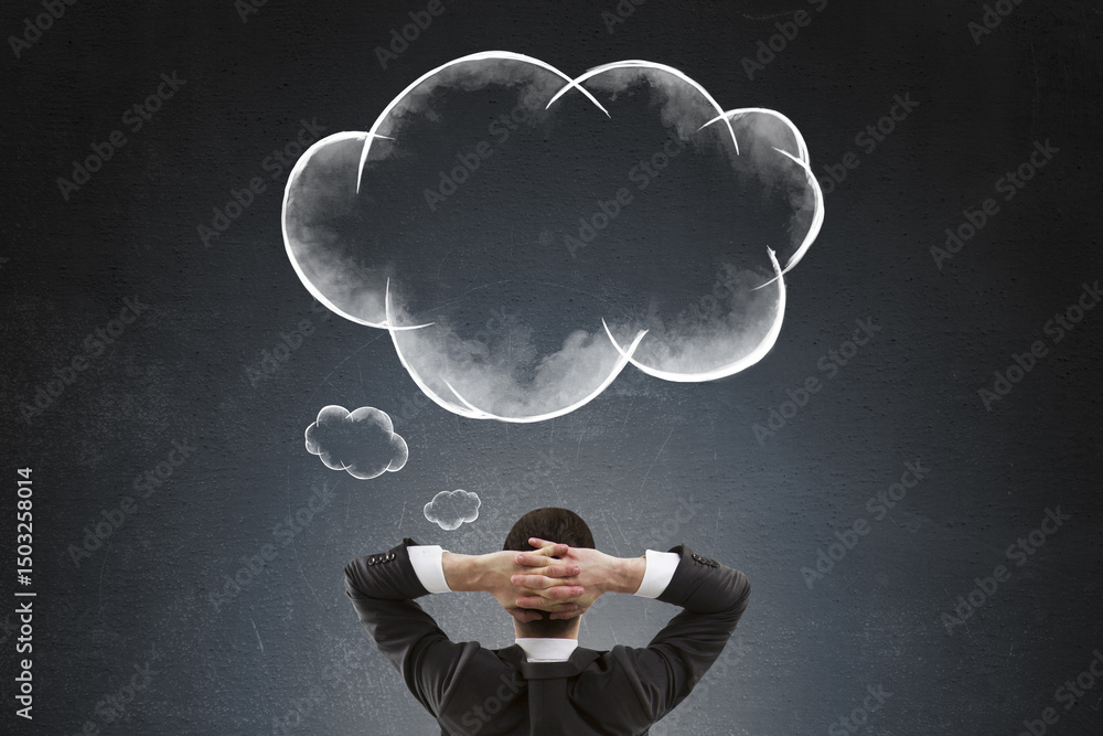 Aufkleber Rear view of businessman thinking with hands behind head looking at cloud-shaped thought bubbles on dark background symbolizing brainstorming.