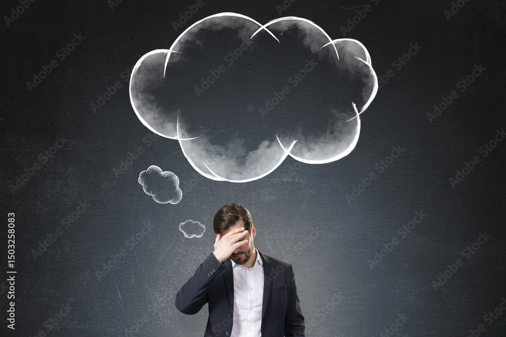 Poster Frustrated businessman standing in front of a large cloud-shaped sketch on dark background representing confusion or mental overload.