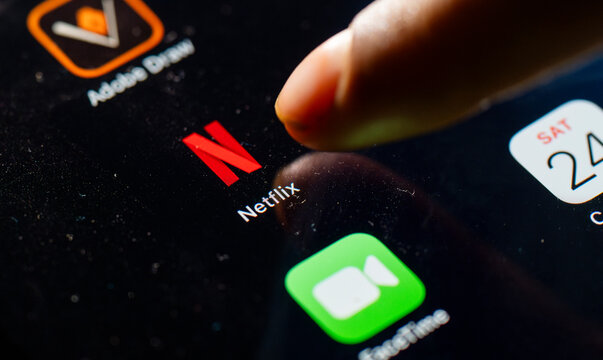In this photo Illustration a person taps Netflix App icon on a tablet device on 24 May 2025 in New Delhi, India.