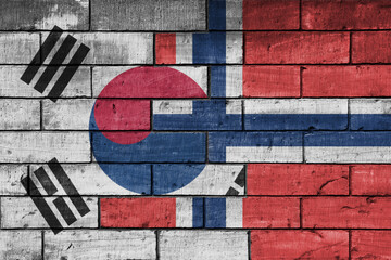 Fototapeta premium colourful painted big national flag of south korea and flag of norway on a massive old brick wall background. concept