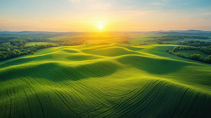 Pastel toned aerial view of layered farmland at sunrise, showcasing soft hues and gentle light over patchwork fields with serene rural beauty and natural patterns.

