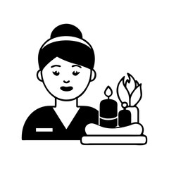 A woman in spa uniform with candles and flowers for relaxation