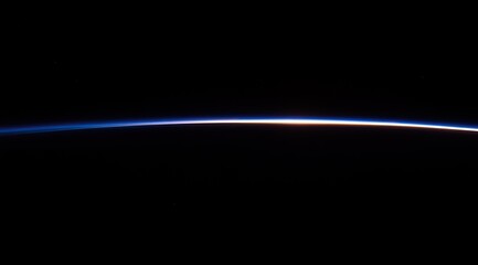 Earth's limb, a thin, luminous line against the inky void of space