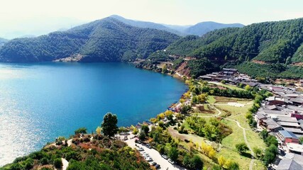 Lugu lake aerial view with mosuo village and mountains during daytime - Powered by Adobe