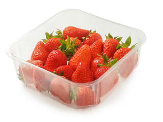 Plastic tray with tasty fresh strawberry on white background. Fine juicy fruit for sale. Organic...