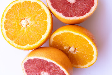 Juicy orange and grapefruit halves on white background, vibrant citrus fruits, fresh and healthy,...