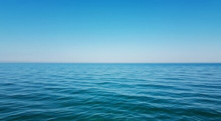 Obraz premium Calm turquoise sea under a clear blue sky on a sunny day