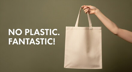 Woman holding reusable cotton shopping bag with slogan “no plastic fantastic”. Eco-friendly concept of zero waste and sustainable living International Plastic Bag Free Day