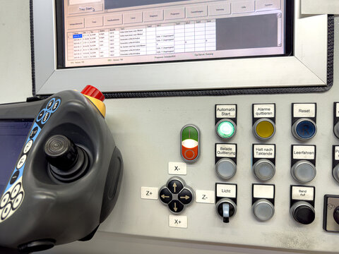 Control panel displays operational status and controls for industrial machinery in a manufacturing facility during daytime