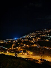 Funchal at night, Madeira Island lit by thousands of lights cascading down the hillsides to the...