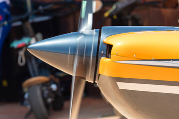 Close-up view of a yellow aircraft propeller with blurred motion at an aviation event