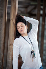 Fototapeta premium Woman beauty style fashion portrait , Outdoor fashion of stylish young woman with natural make-up on the background of a wooden vintage wall