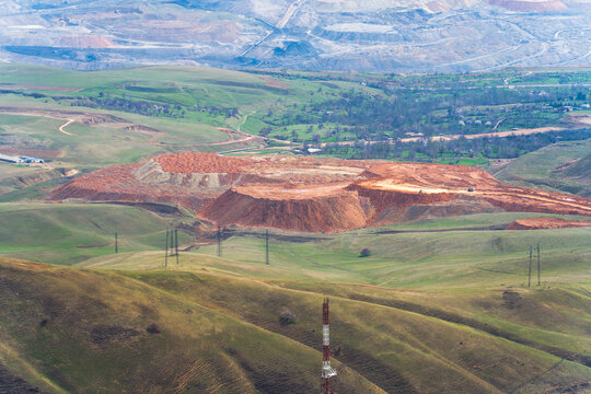 Distant view of Angren's open pit coal mine with access ramp in Uzbekistan