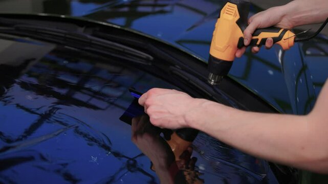 The Professional Windshield Tinting Process Conducted in a Modern Auto Showroom Environment